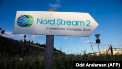 GERMANY -- A road sign directs traffic towards the Nord Stream 2 gas line landfall facility entrance in Lubmin, north eastern Germany, September 7, 2020